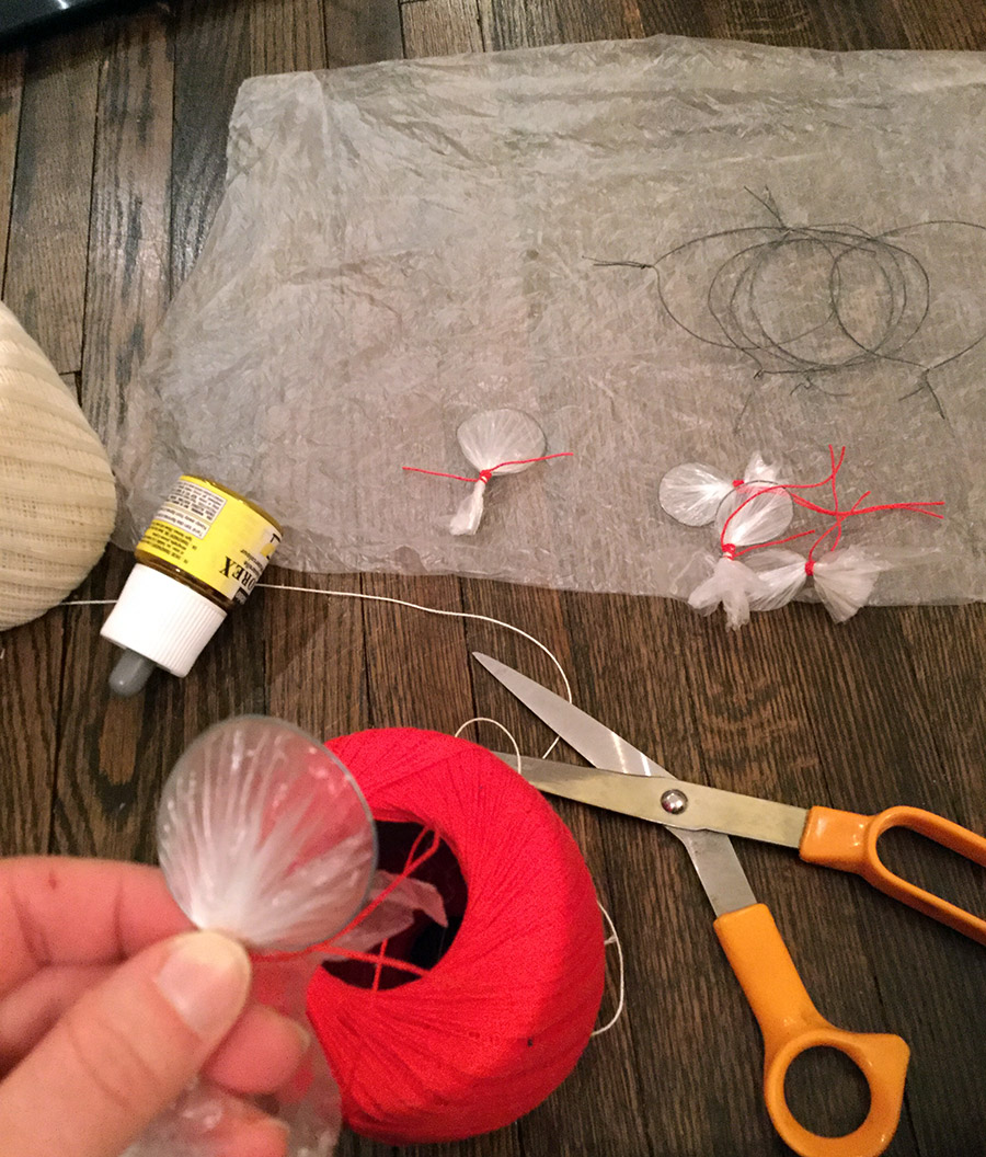 A single petal made of a layer of plastic bag over a round of wire.